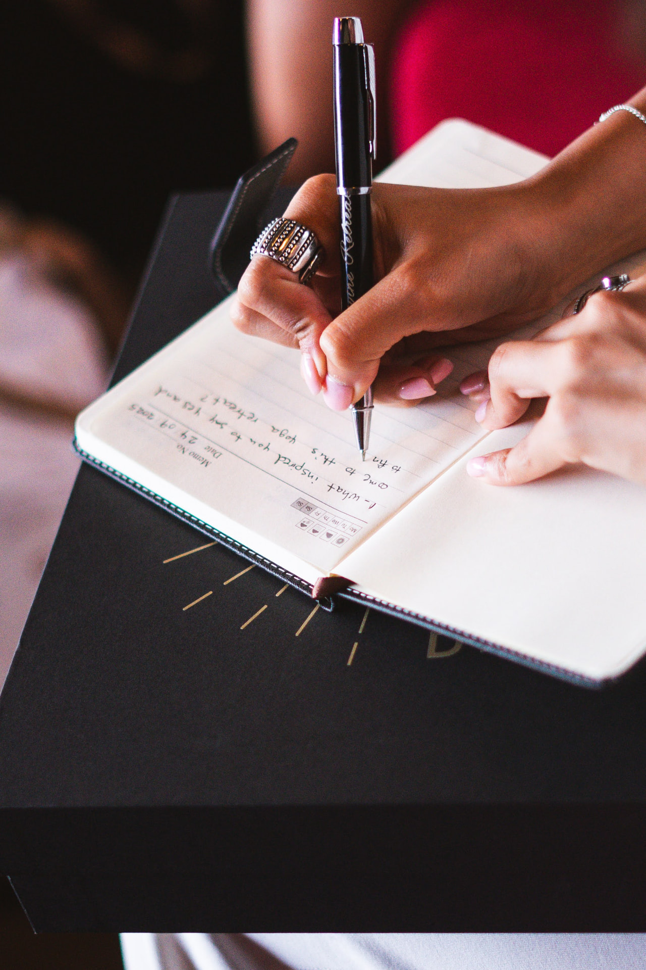 Retreat guest journaling in a leather notebook during a reflection session.